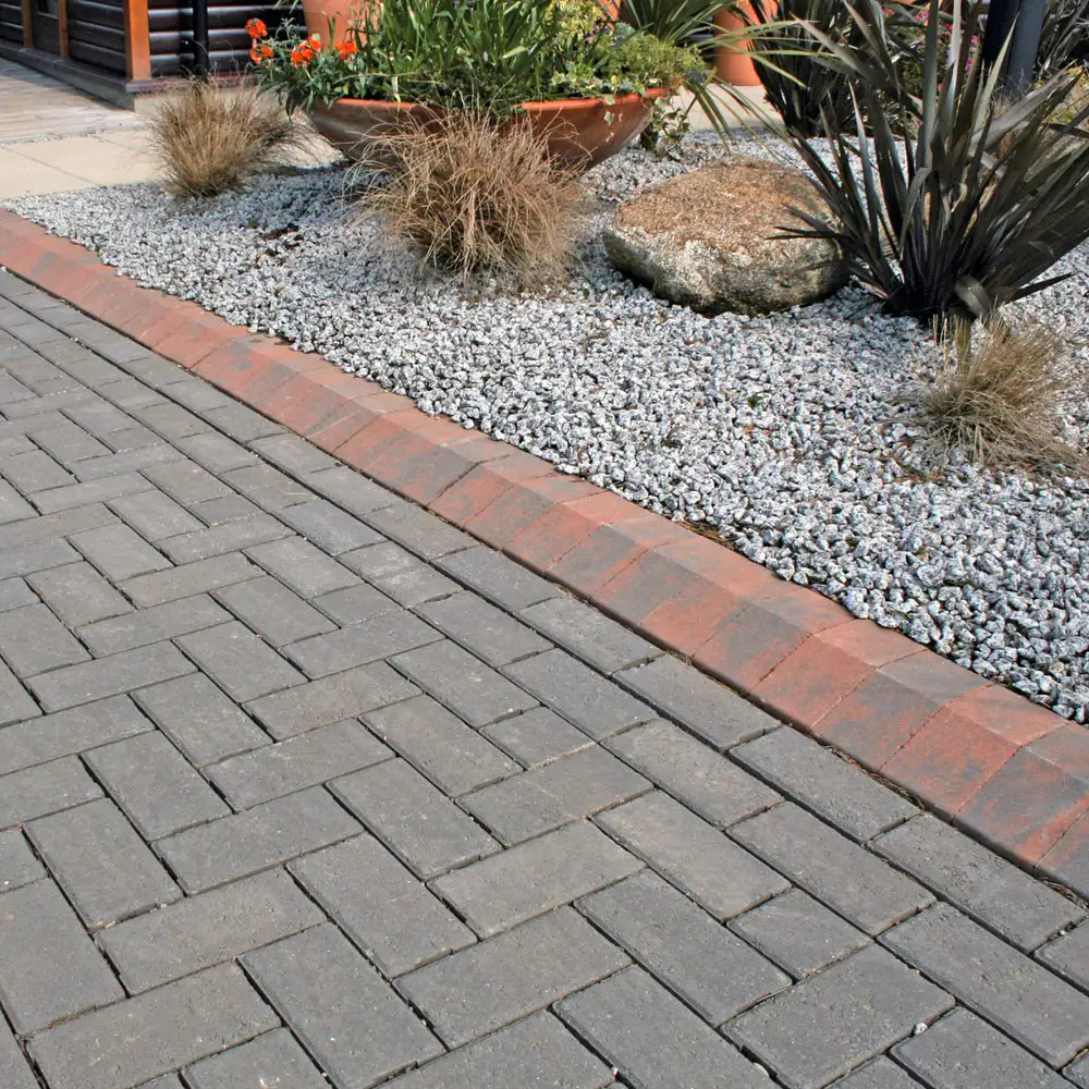Detailed block paving finished with a red kerb course