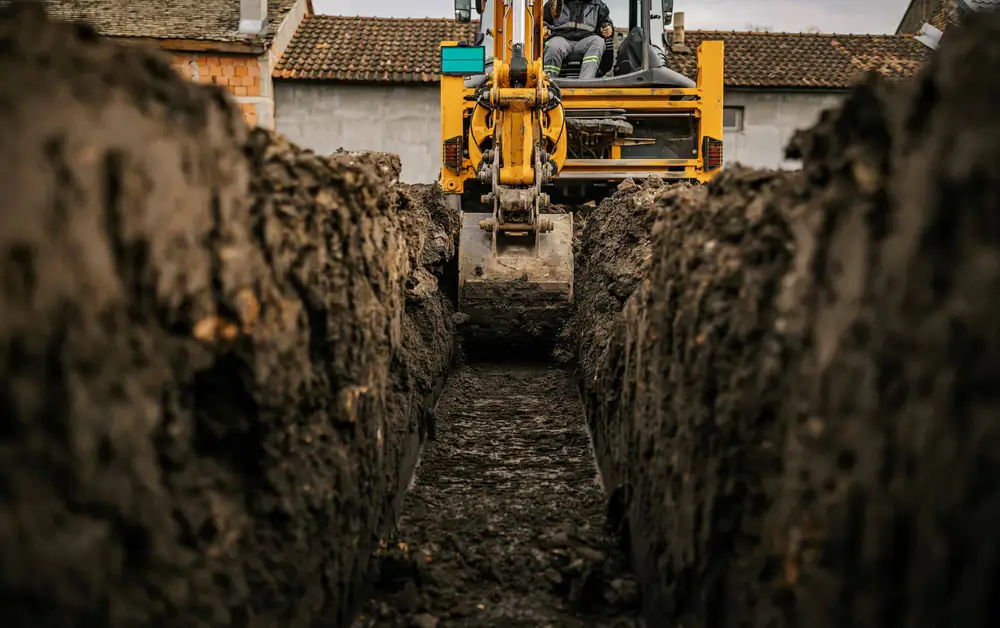 Machine excavation of a deep service trench